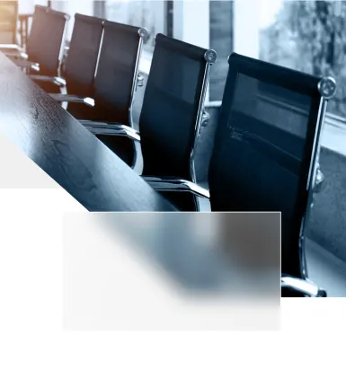 Grey geometrical shapes surrounding an image of a boardroom